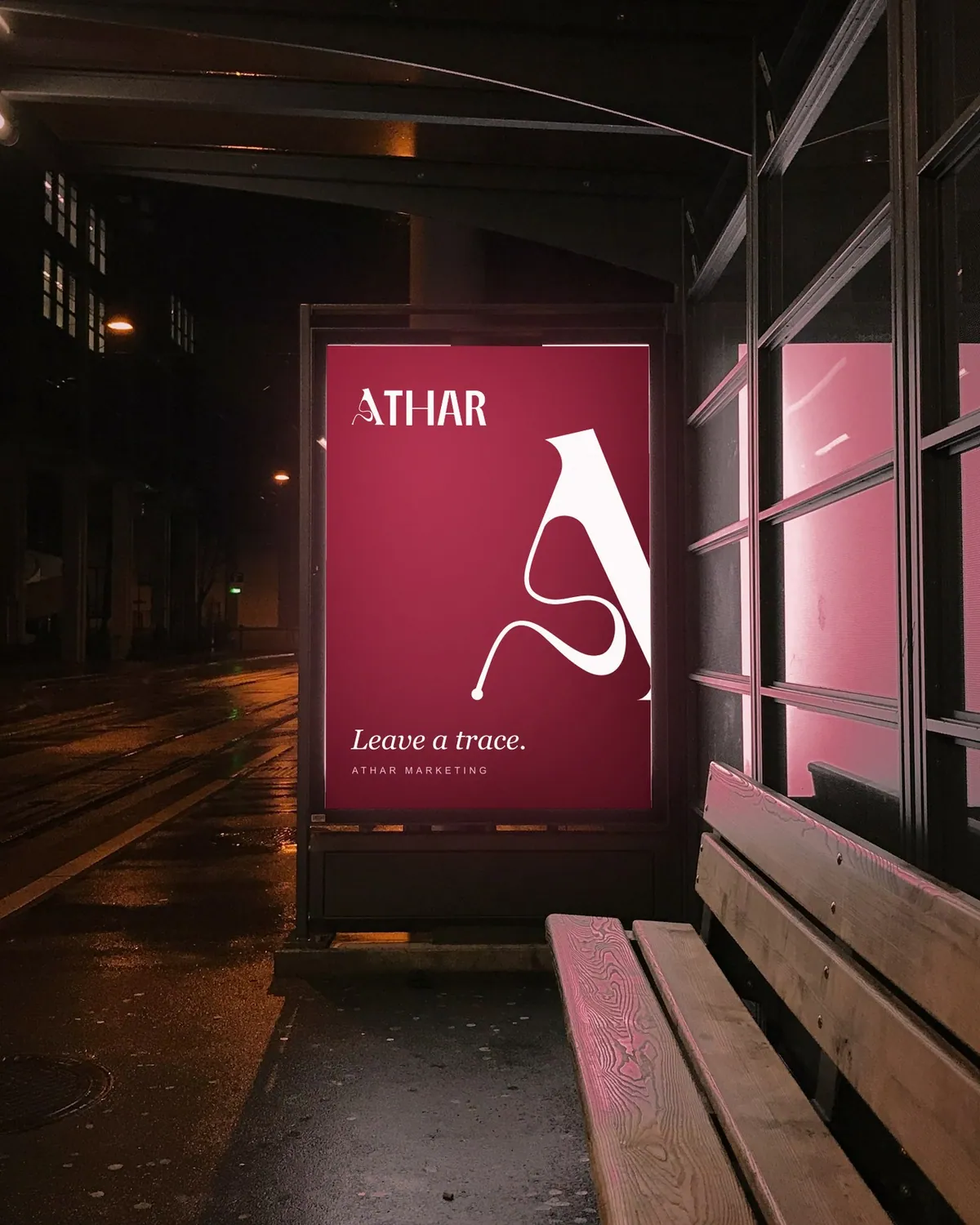 Athar poster lit up in a bus shelter at night