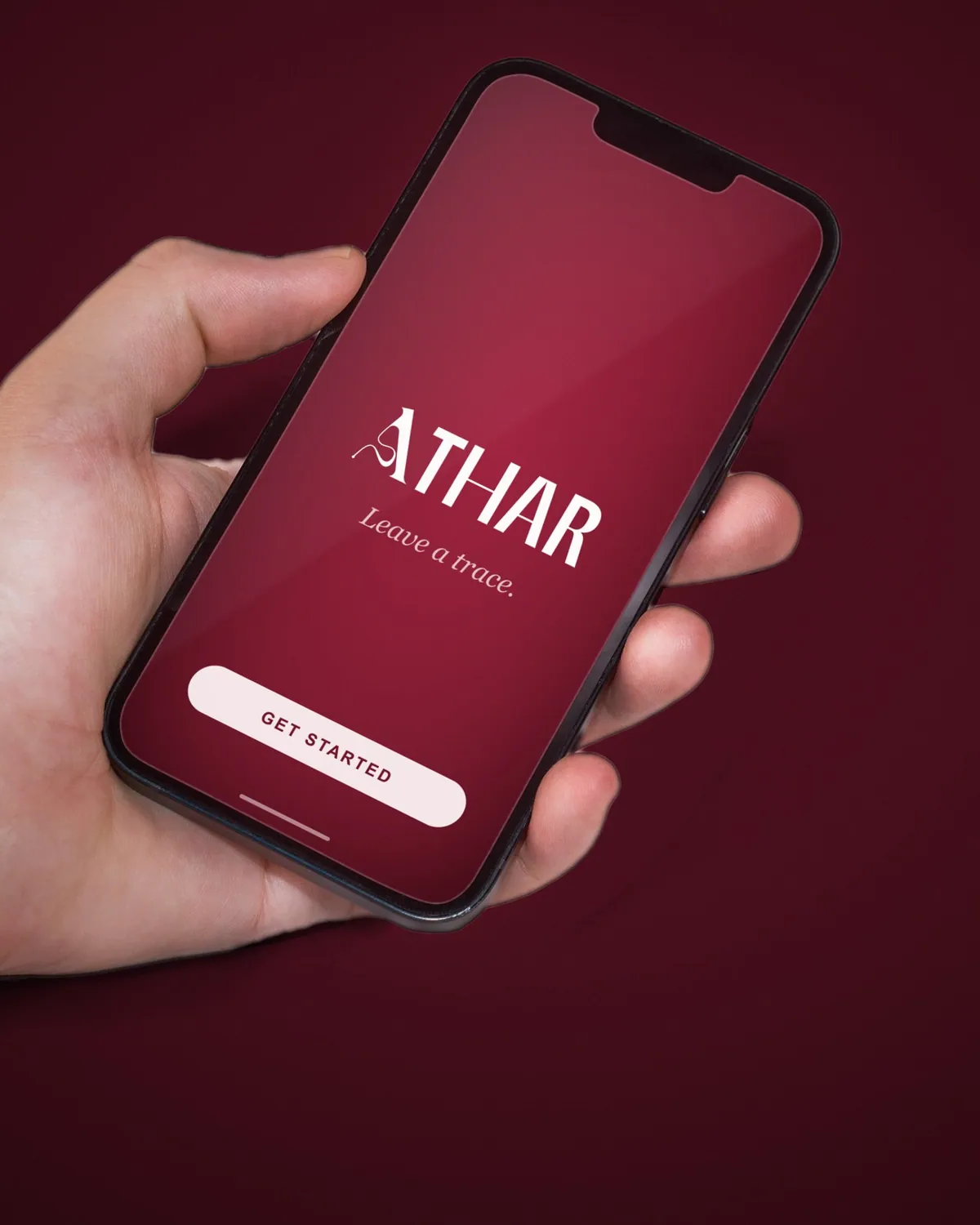 Athar app opening screen on a phone in hand