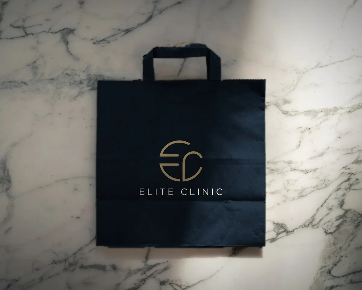 Navy Elite Clinic paper bag on white marble