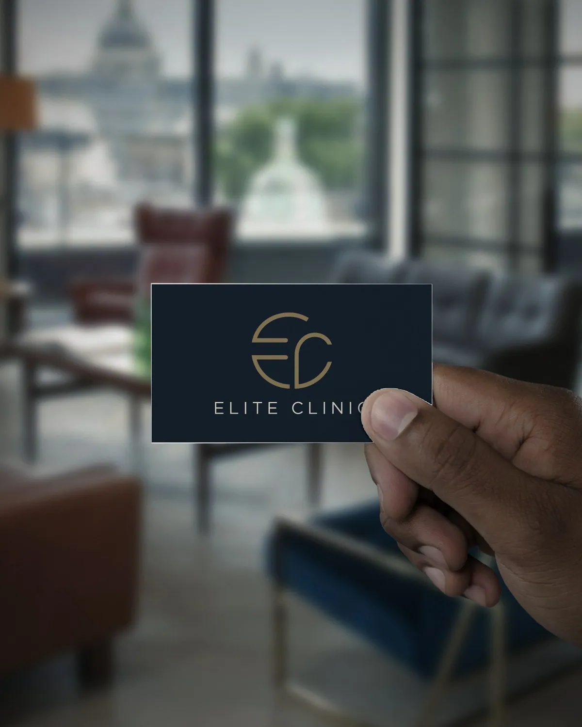 Elite Clinic card in navy and champagne, held in a lounge