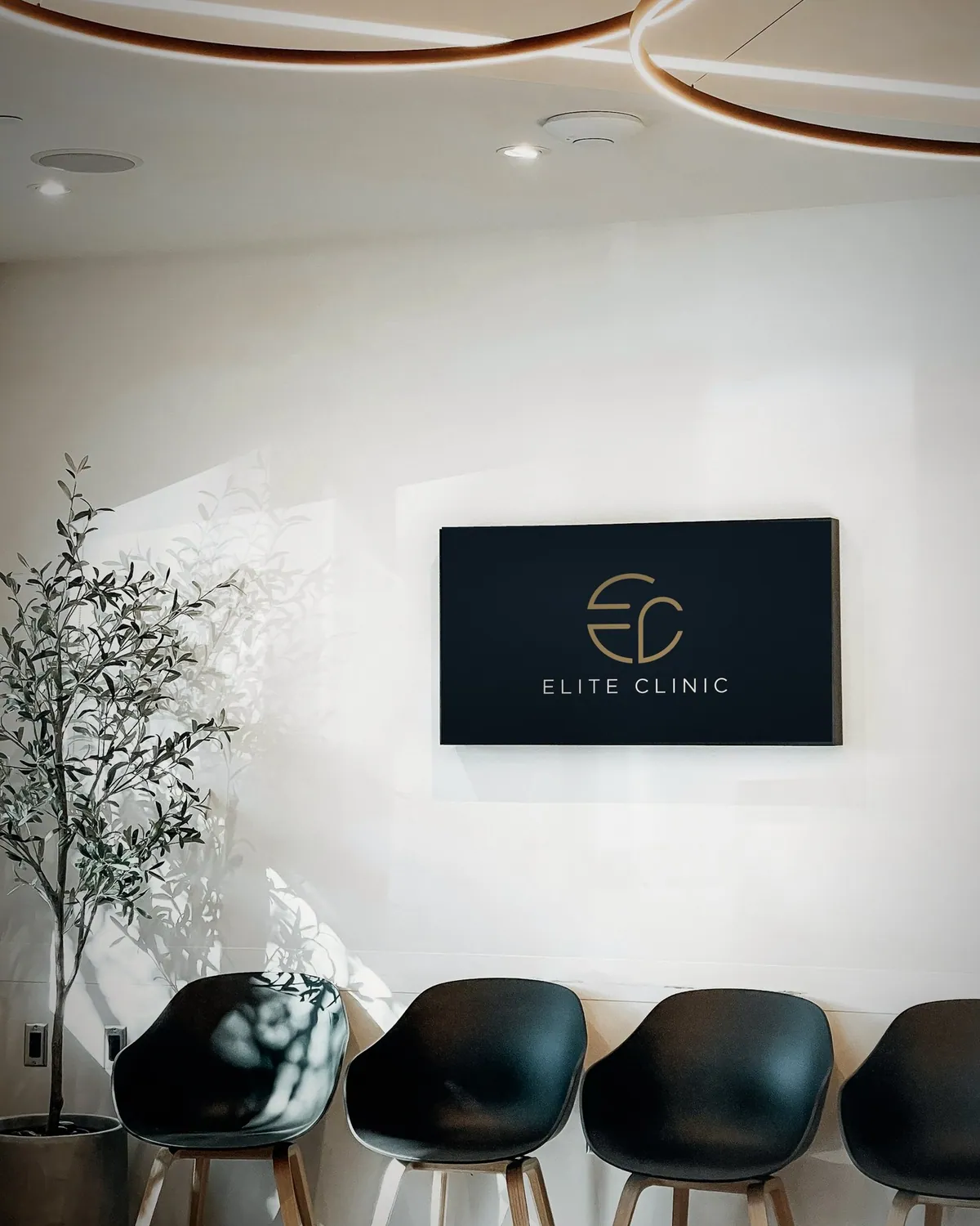 Elite Clinic panel on the waiting-room wall above the chairs