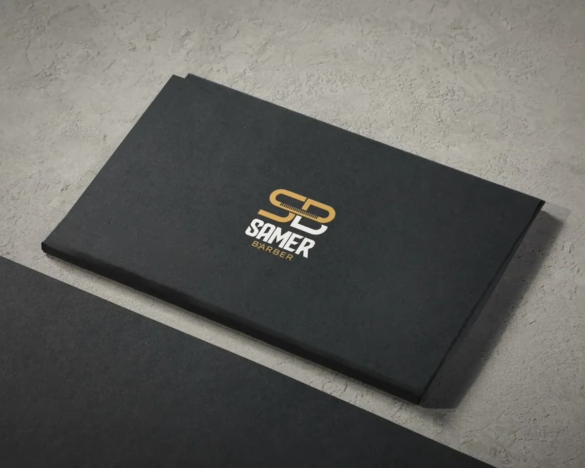 Black Samer Barber card with the logo in gold foil