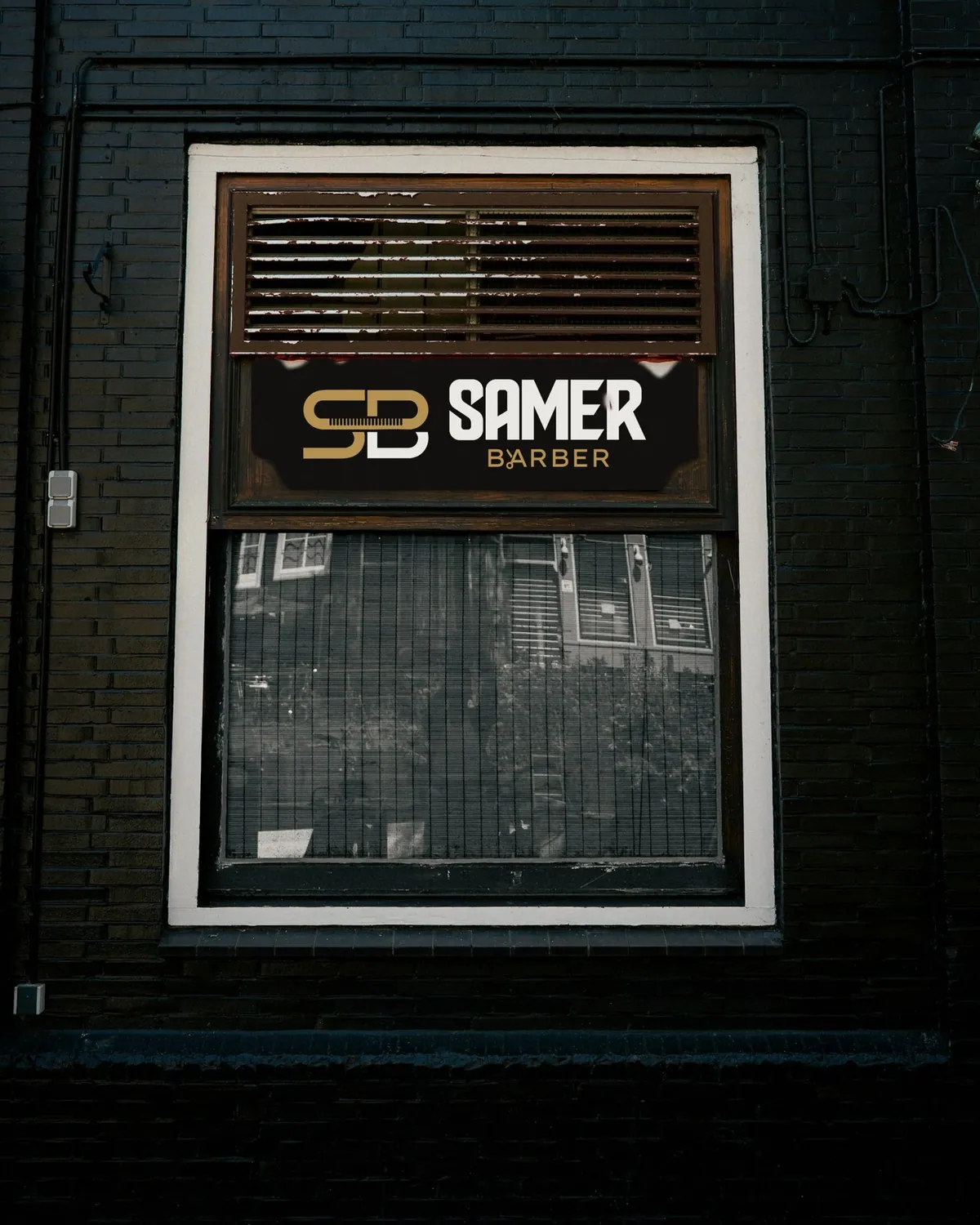 Black Samer Barber sign above a shop window