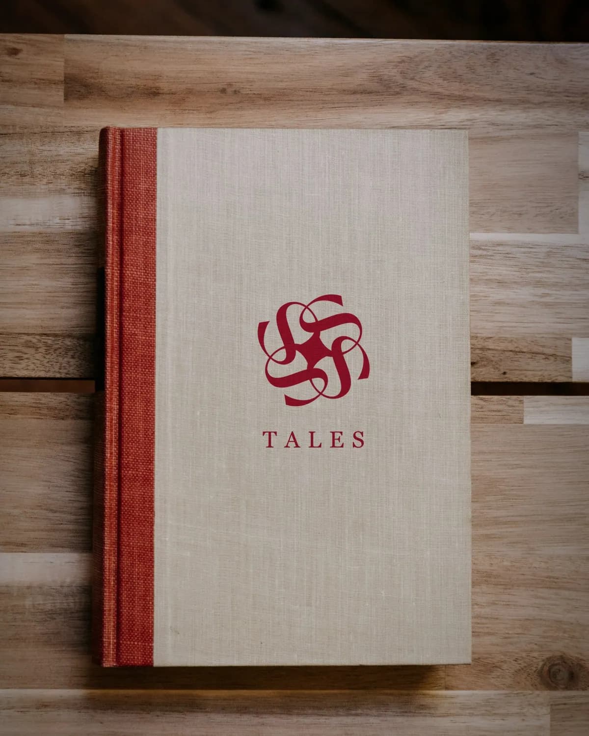 Tales rosette and name stamped on a linen book cover